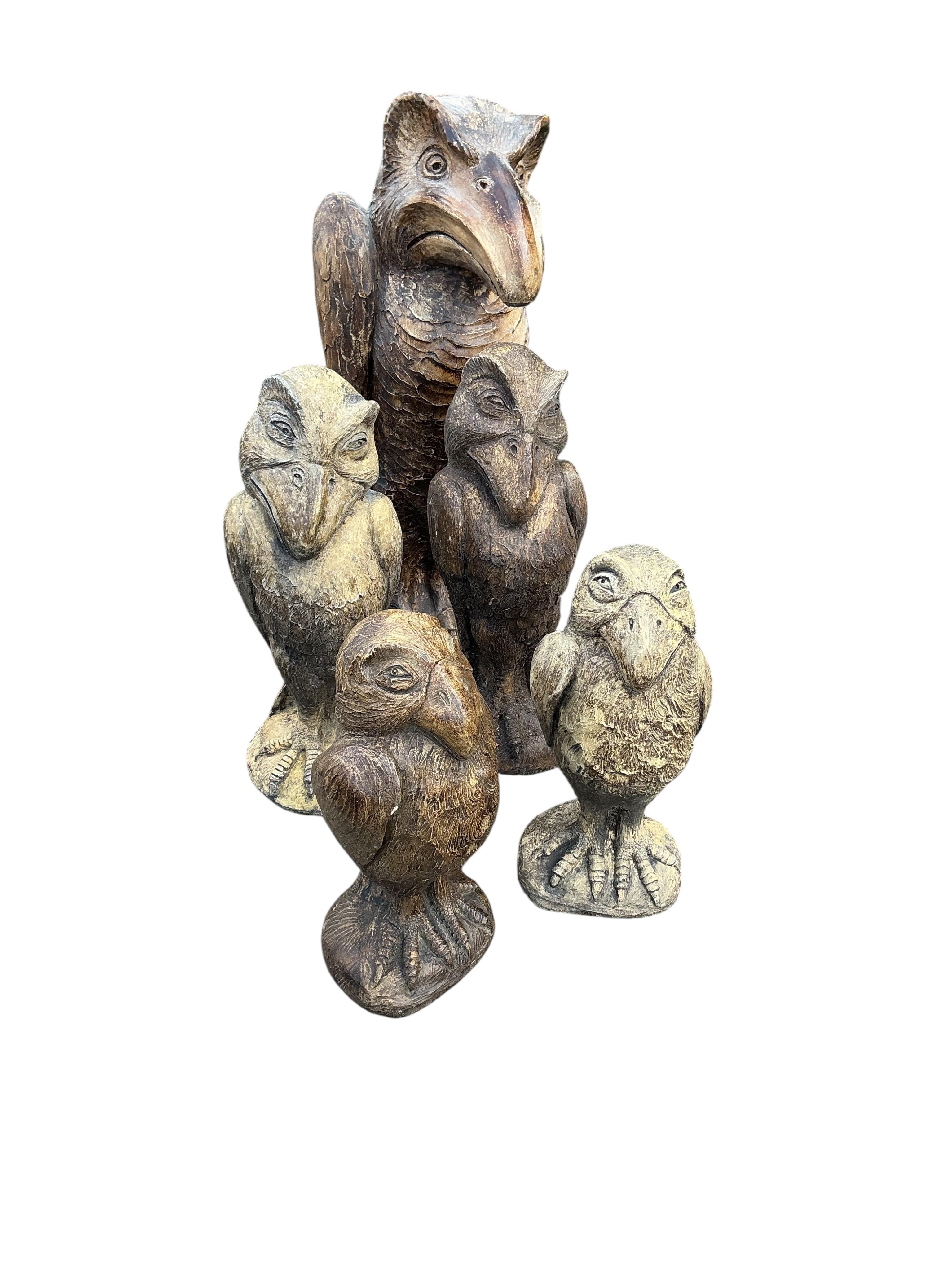 Five cast stone 'Wally' bird ornaments in the style of Martin Bros., largest height 48cm